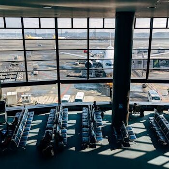 Spacious airport terminal with airplane and tarmac view in Tokyo, Japan.